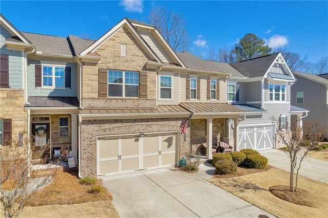 2735 Kimblewick Ct, Cumming, GA 30040 - view of front facade with driveway, a standing seam roof, stone siding, and brick siding