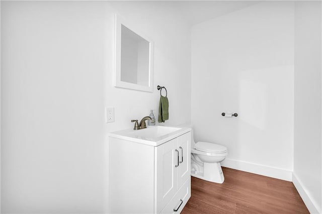 2735 Kimblewick Ct, Cumming, GA 30040 - bathroom with baseboards, vanity, toilet, and wood finished floors