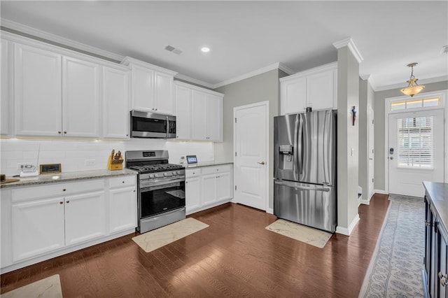 2735 Kimblewick Ct, Cumming, GA 30040 - kitchen featuring dark wood-type flooring, visible vents, white cabinets, appliances with stainless steel finishes, and decorative backsplash