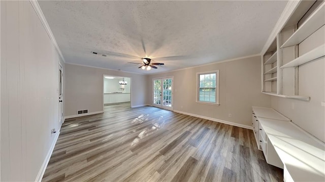 unfurnished living room featuring ornamental molding, a textured ceiling, hardwood / wood-style flooring, and ceiling fan