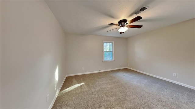 spare room featuring carpet and ceiling fan