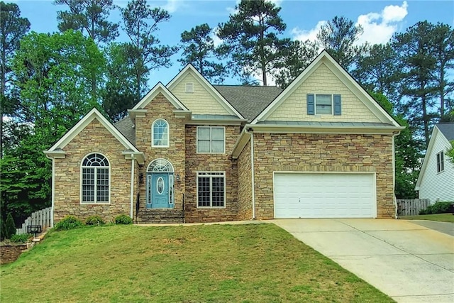 view of front of home featuring fence, a front yard, stone siding, an attached garage, and driveway