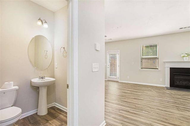 bathroom featuring toilet and hardwood / wood-style flooring