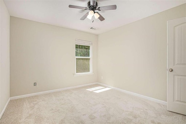 unfurnished room featuring light carpet and ceiling fan