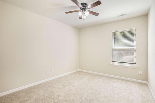 carpeted empty room featuring ceiling fan