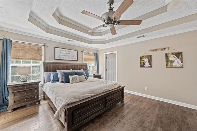 bedroom featuring ornamental molding, multiple windows, ceiling fan, and dark hardwood / wood-style flooring