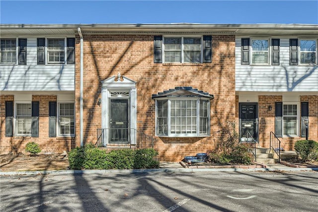 view of property featuring brick siding