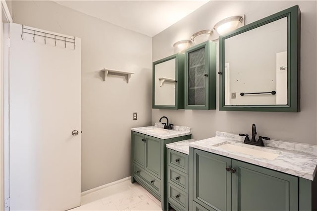 bathroom featuring marble finish floor, baseboards, and vanity