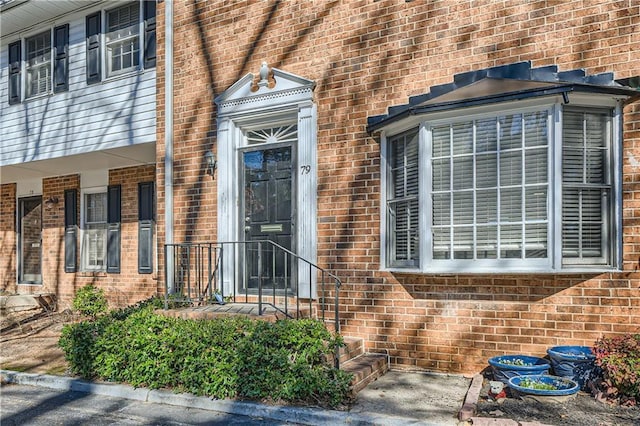 entrance to property with brick siding