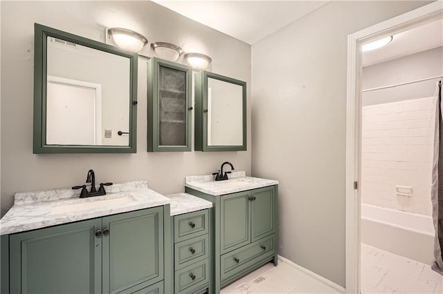 full bathroom with shower / bath combo, two vanities, a sink, and baseboards