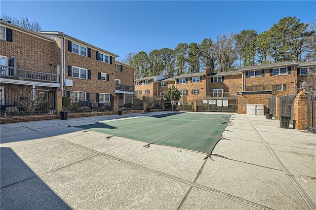 community pool featuring a patio area and fence