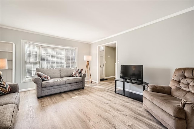 living room featuring crown molding, light wood-style flooring, and baseboards