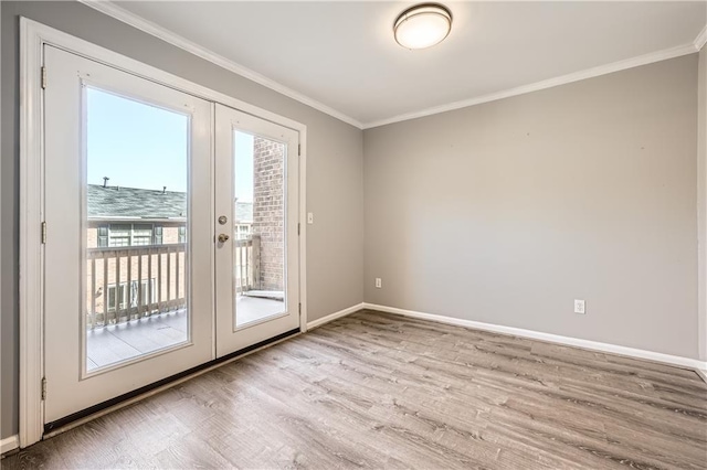 doorway with baseboards, french doors, light wood-style flooring, and crown molding