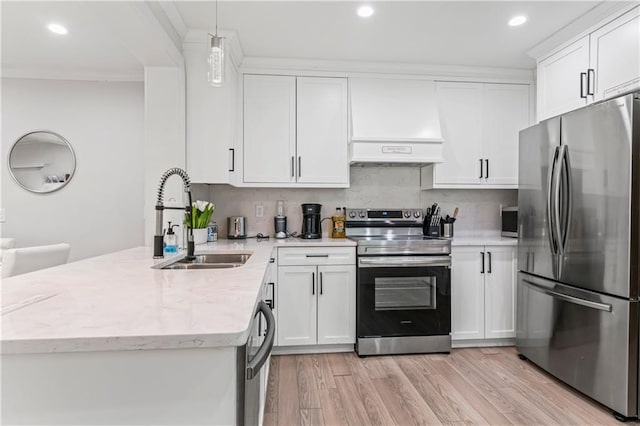 kitchen featuring sink, appliances with stainless steel finishes, white cabinetry, hanging light fixtures, and backsplash