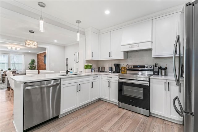 kitchen with white cabinetry, hanging light fixtures, stainless steel appliances, and kitchen peninsula