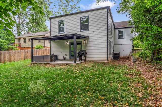 rear view of house with a yard, a patio, and central air condition unit