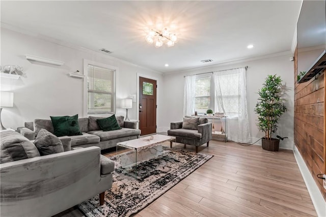 living room featuring ornamental molding and light wood-type flooring