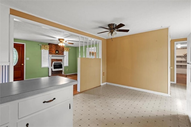 6674 Cowan Mill Rd, Winston, GA 30187 - kitchen featuring a ceiling fan, light flooring, white cabinets, and heating unit