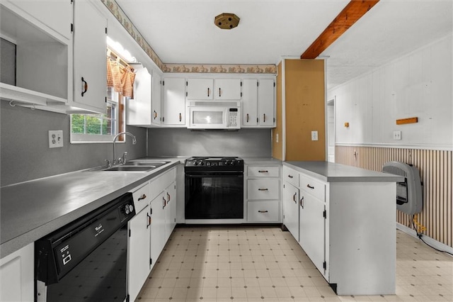 6674 Cowan Mill Rd, Winston, GA 30187 - kitchen featuring black appliances, light floors, a peninsula, white cabinets, and a wainscoted wall