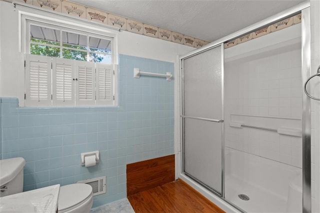 6674 Cowan Mill Rd, Winston, GA 30187 - bathroom with tile walls, a stall shower, and a textured ceiling