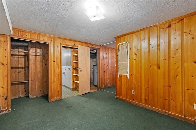 6674 Cowan Mill Rd, Winston, GA 30187 - unfurnished bedroom featuring carpet, wooden walls, gas water heater, and a textured ceiling
