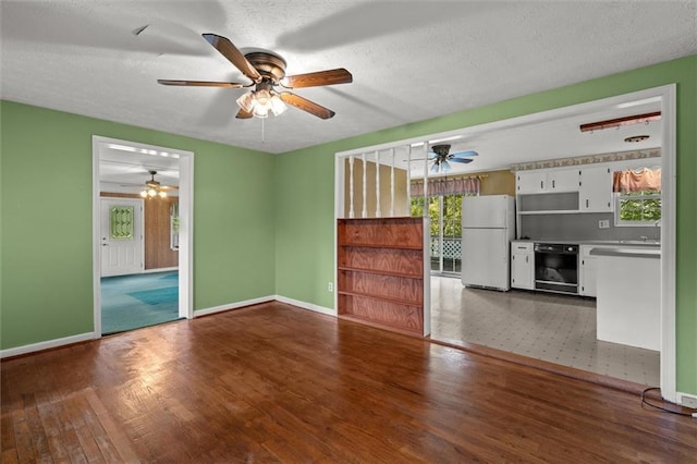 6674 Cowan Mill Rd, Winston, GA 30187 - unfurnished living room with a ceiling fan, wood finished floors, and a textured ceiling