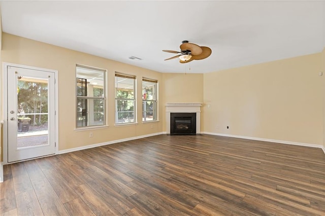 unfurnished living room with dark wood-type flooring and ceiling fan