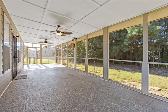 unfurnished sunroom with a paneled ceiling and ceiling fan