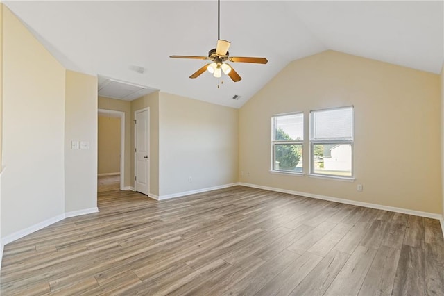 spare room featuring ceiling fan, lofted ceiling, and light wood-type flooring