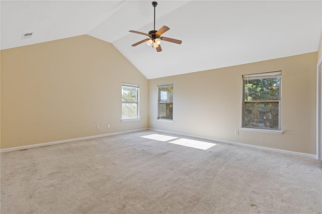 spare room featuring light carpet, high vaulted ceiling, and ceiling fan