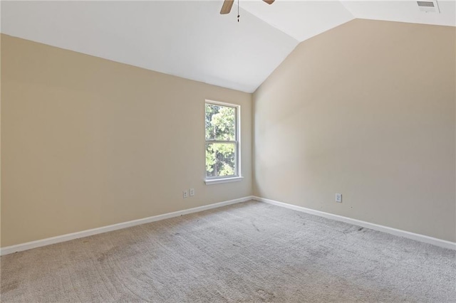 carpeted empty room featuring vaulted ceiling and ceiling fan