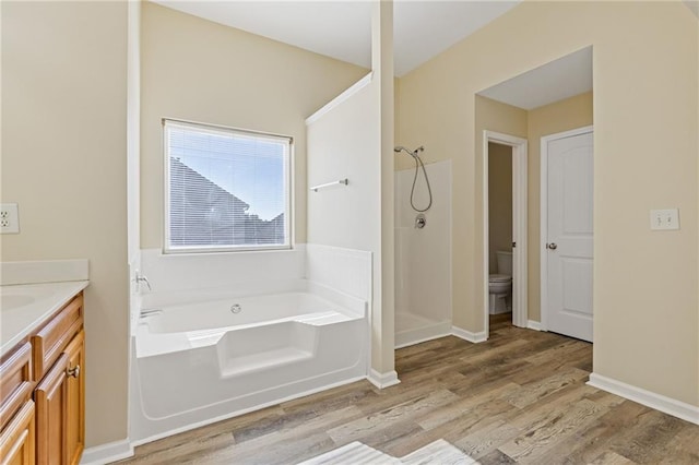 full bathroom with toilet, vanity, wood-type flooring, and independent shower and bath