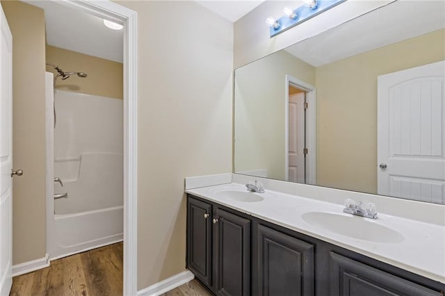 bathroom featuring vanity, hardwood / wood-style floors, and  shower combination