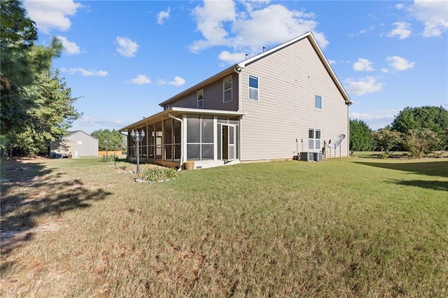 back of house featuring a lawn and a sunroom