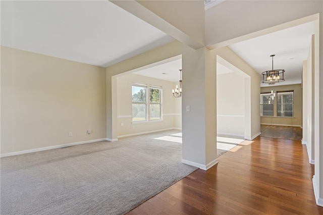 unfurnished living room featuring hardwood / wood-style flooring and a notable chandelier