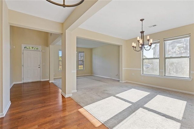 foyer featuring a notable chandelier and wood-type flooring