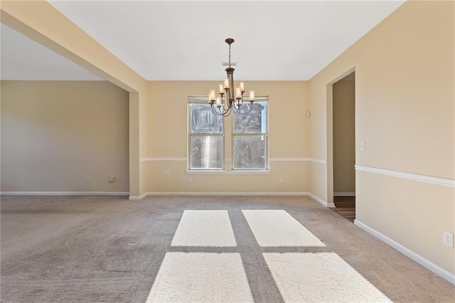 unfurnished dining area featuring an inviting chandelier and light colored carpet