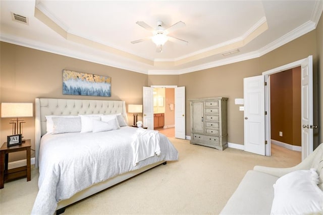 bedroom with a tray ceiling, light colored carpet, ornamental molding, baseboards, and ceiling fan