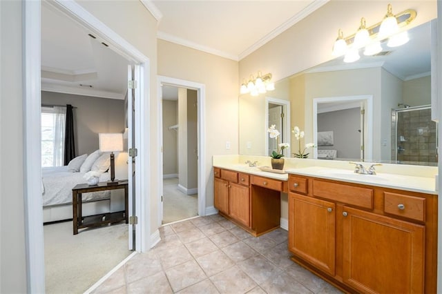 ensuite bathroom with a shower stall, double vanity, ornamental molding, tile patterned flooring, and baseboards