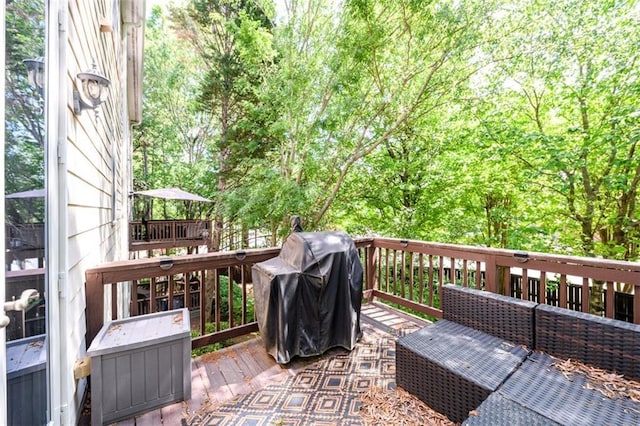 wooden deck featuring a grill