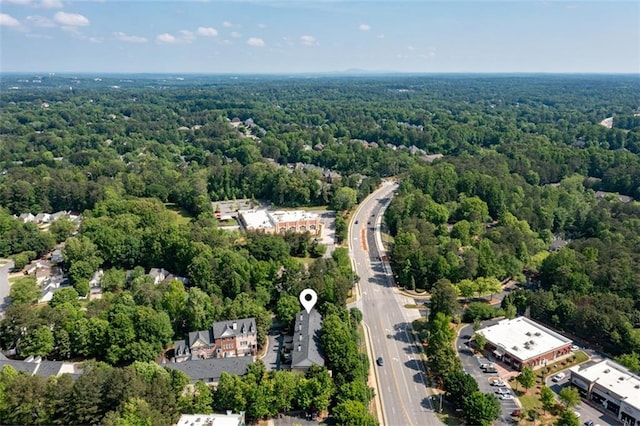 bird's eye view of a heavily wooded area and a main thoroughfare