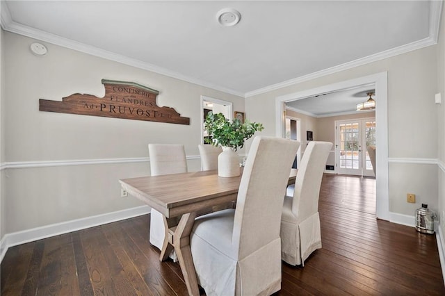 dining room featuring dark hardwood / wood-style flooring and ornamental molding