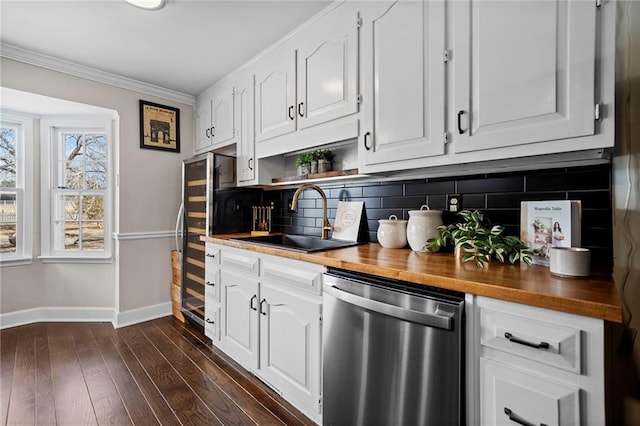 kitchen with white cabinets, dishwasher, sink, and butcher block countertops