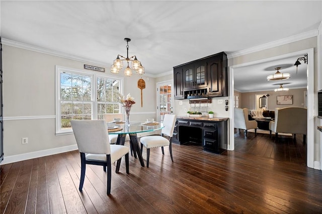 dining room featuring ornamental molding, a chandelier, and dark hardwood / wood-style flooring