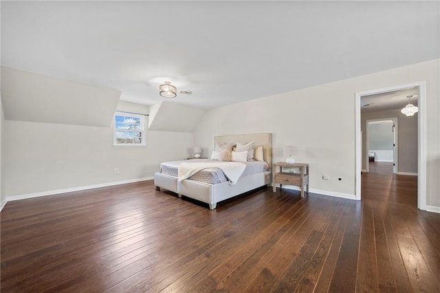 bedroom featuring vaulted ceiling and dark wood-type flooring