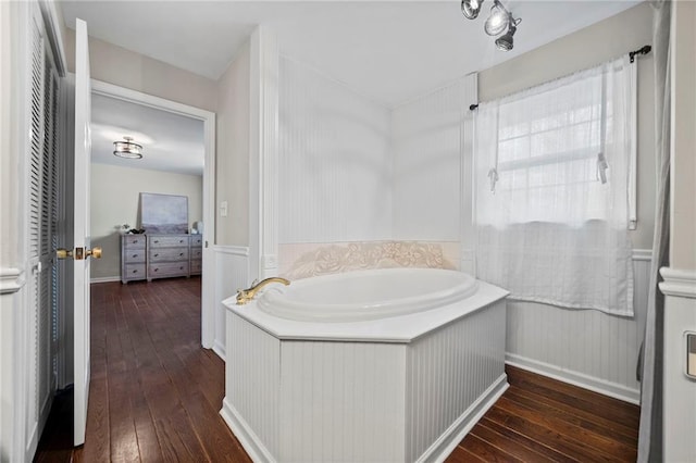 bathroom featuring a bath and hardwood / wood-style floors