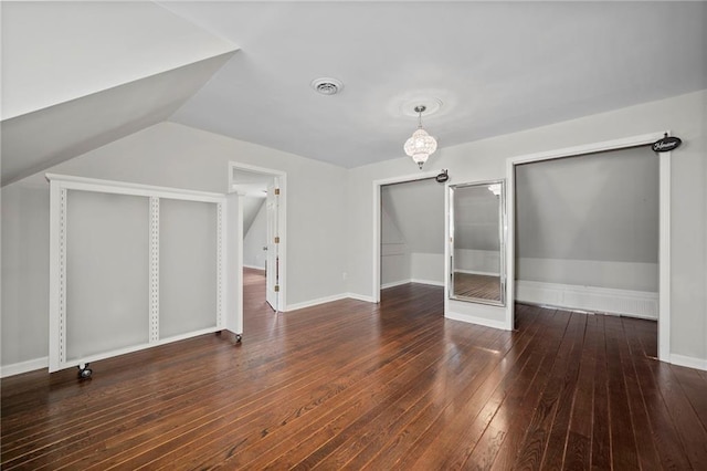 additional living space with dark hardwood / wood-style floors and vaulted ceiling