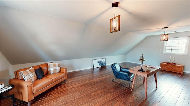 sitting room with dark wood-type flooring and vaulted ceiling