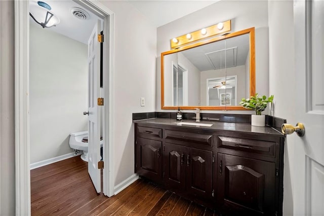 bathroom featuring hardwood / wood-style flooring, vanity, and toilet