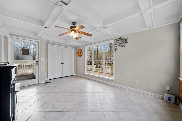 tiled entryway with ceiling fan, coffered ceiling, and beam ceiling